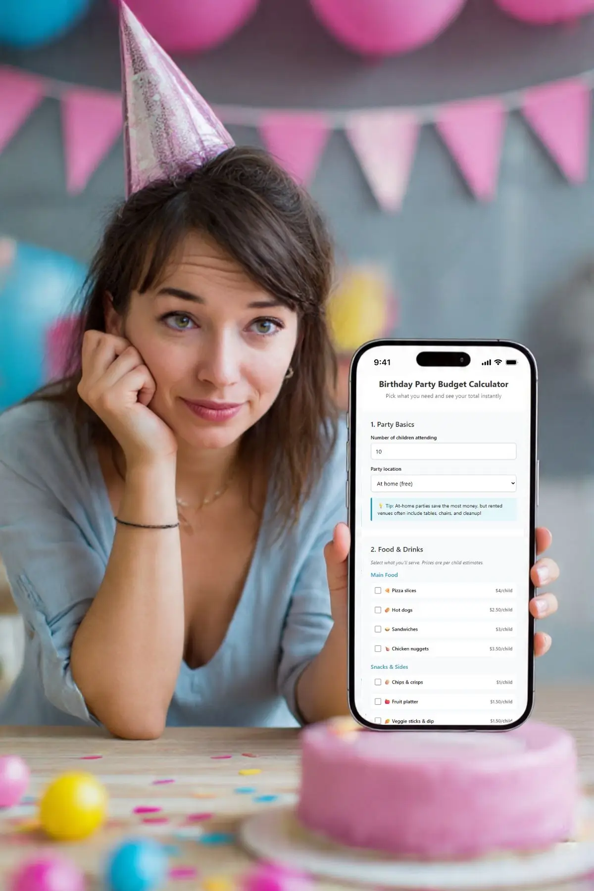 Woman in party hat shows birthday party budget calculator app beside pink cake and decorations